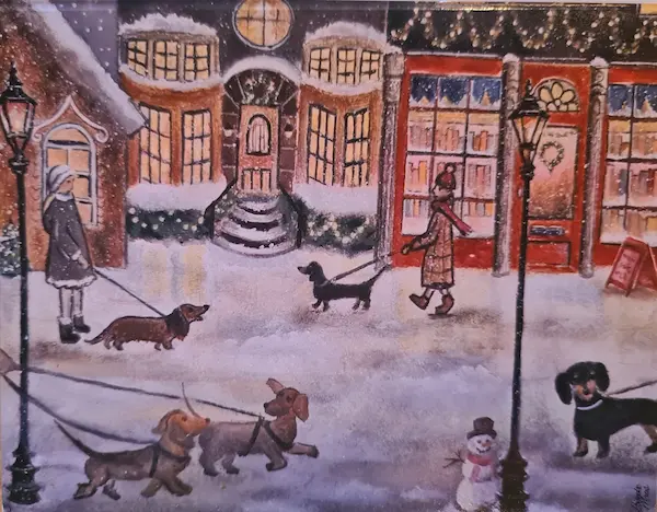 Wenskaart met illustratie van Teckels in een kerst dorp.